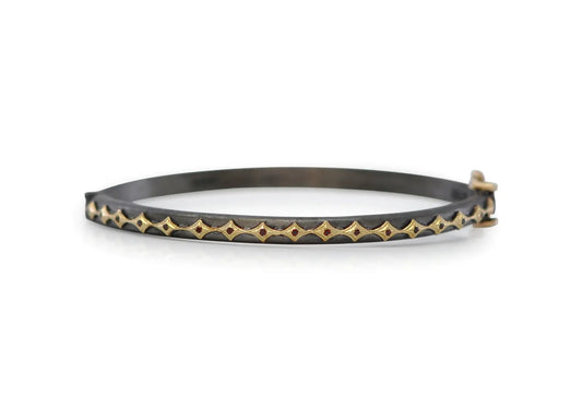 18k yellow gold and BLACKENED sterling silver eternity crivelli huggie bracelet with red garnets. BRACELET Size 57